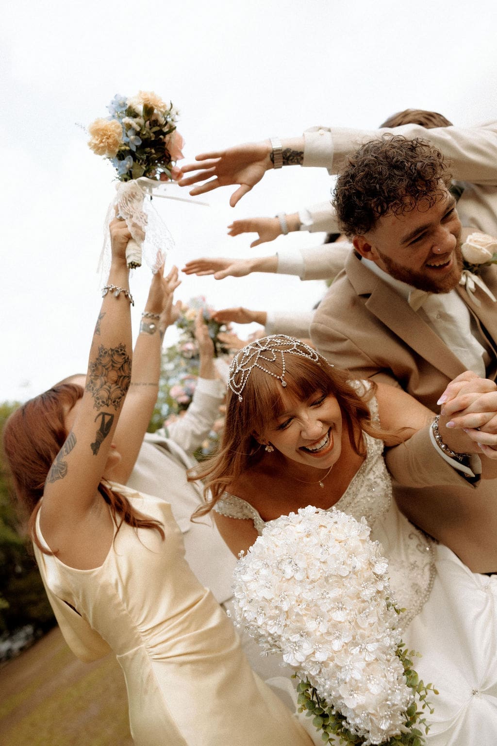 Bride and groom run through a cheering guest tunnel during their spring wedding at Historic Malbis Nursery in Malbis, Alabama