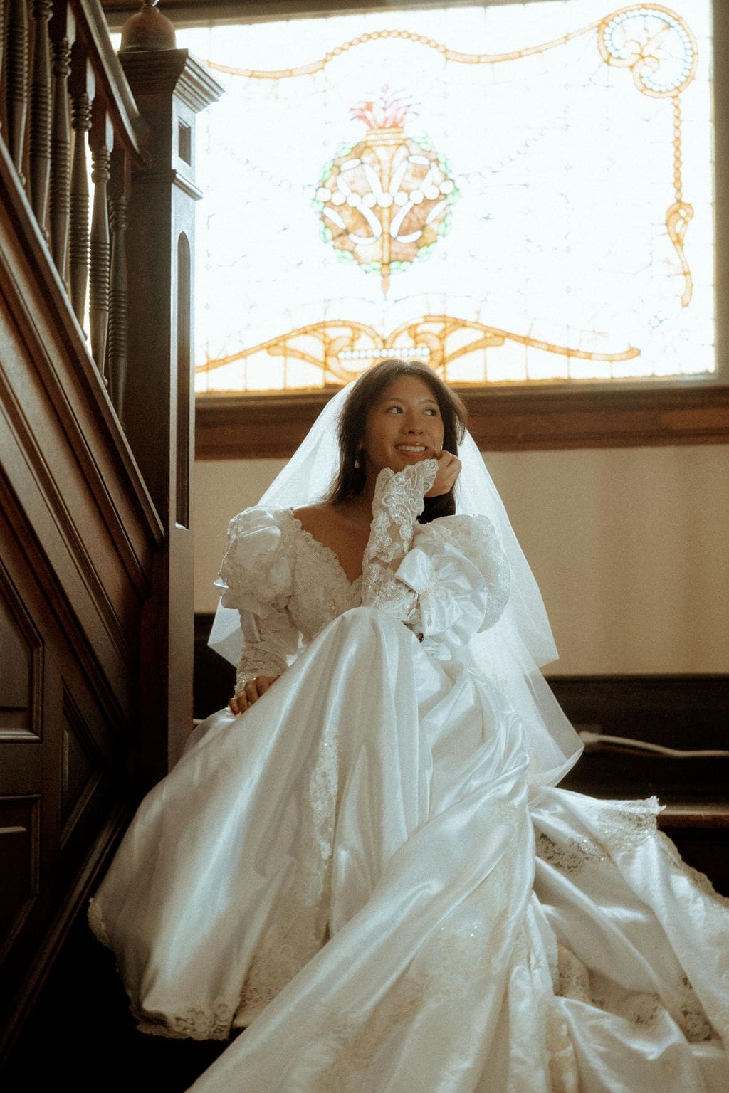 Bride standing on the staircase inside the historic Kate Shepard House in Mobile, Alabama on her wedding day
